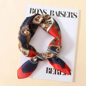 Close-up of vintage baroque satin scarf with nautical print on a fashion magazine