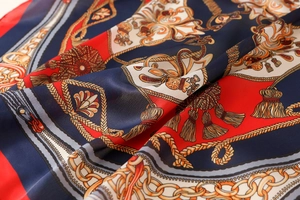 Detailed close-up of premium satin scarf fabric with nautical chain and rope print patterns