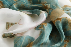 Detailed macro view of the silky lotus print fabric with smooth satin finish and elegant drape