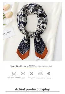 Close-up of paisley pattern silk scarf with contrast edges and washing instructions