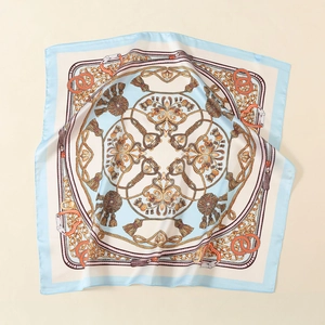 Close-up of elegant equestrian silk scarf with intricate rope pattern and light blue edges