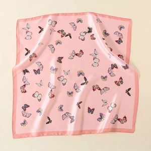 Detailed view of pink satin scarf featuring vibrant butterfly prints and smooth finish