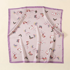 Close-up of pink satin square scarf with butterfly print and purple border detail