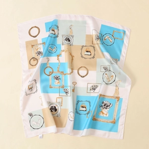 Macro detail of satin silk scarf featuring retro blue geometric prints and vintage lady portraits