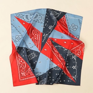 Close-up of silk satin scarf featuring red and blue paisley patterns and smooth texture