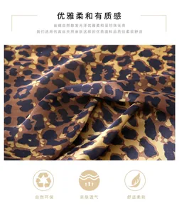Detail of silk satin fabric with classic leopard print showing smooth texture and luster