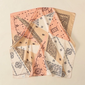 Detail of silk satin square scarf with paisley print in pink and beige tones