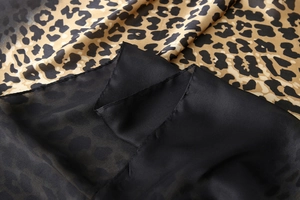Close-up of leopard print fabric stitched with sheer black silk chiffon texture