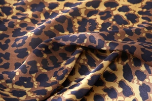 Close-up of lightweight leopard print faux silk scarf with soft texture and elegant drape