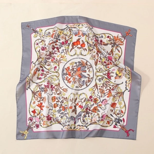Detail of satin square scarf with vintage floral and bird prints on silky fabric