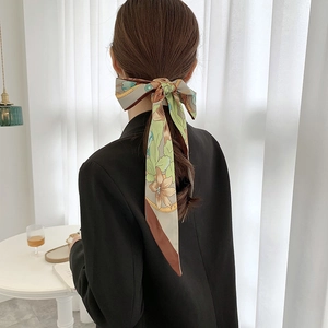 Elegant floral satin skinny scarf tied as a bow on hair with retro flower patterns