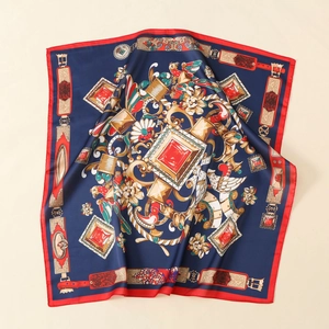 Detail of luxury satin square scarf featuring vintage jewelry prints and silk texture