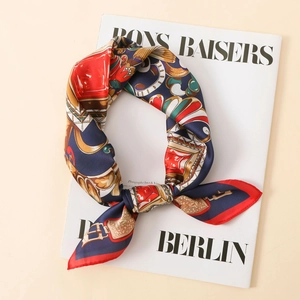 Detail of satin floral scarf with vintage jewelry print on white fashion magazine