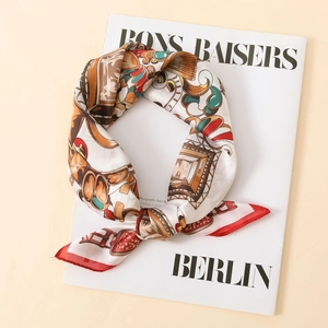 Elegant satin square scarf with vintage jewel print on a stylish magazine background