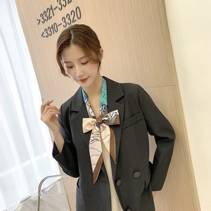 Floral skinny silk scarf for women styled with a grey blazer in a minimalist aesthetic