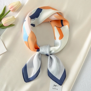 Close-up of abstract patterned satin silk scarf with elegant knotting and tulip decor