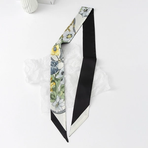 Detailed view of floral silk neck scarf with double-sided pattern and elegant bias cut