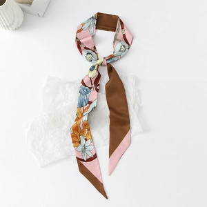 Close-up of floral print twilly scarf with elegant chain pattern and silky texture