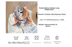 Detail view of 17x150cm silk-like scarf with orange leaf print and washing instructions