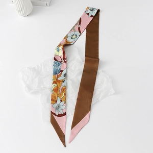 Macro detail of a floral twilly silk scarf featuring blue flowers and a solid brown back