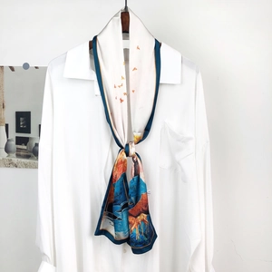 Artistic landscape and deer print detail on silky scarf styled with white shirt