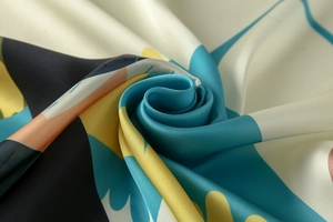 Detailed macro view of soft silk satin scarf with abstract modern art color block print