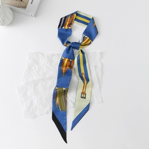 Detail of floral silk twilly scarf with elegant equestrian pattern on white background