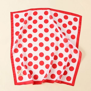 Detail of satin scarf with classic red and white polka dots and a butterfly print