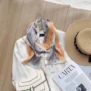 Detailed view of long silk-feel scarf with ink painting pattern on white suit