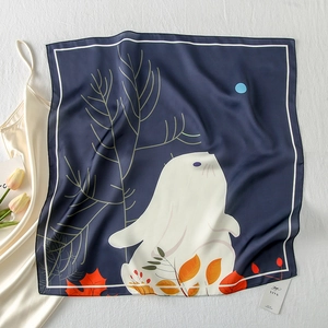 Close-up of silk-satin square scarf with rabbit and autumn leaf illustration
