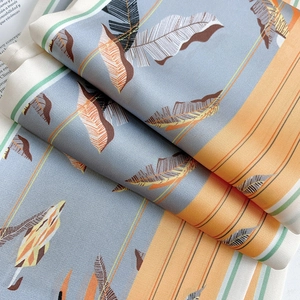Detailed macro shot of abstract leaf print silk scarf with luxury smooth texture and sheen