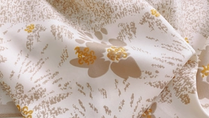 Detailed close-up of summer floral silk scarf fabric showing fine twill texture and print