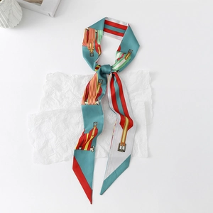 Detail of peacock blue silk twilly scarf with vintage belt buckle pattern and red stripes
