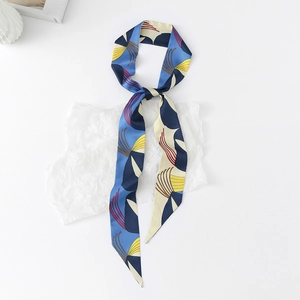 Detail of floral printed twilly silk scarf with vibrant blue and beige abstract patterns