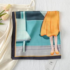 Close-up detail of satin silk scarf featuring artistic illustration and premium black edging
