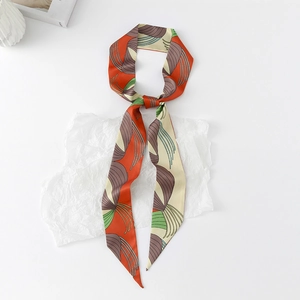 Detail of artistic floral skinny silk scarf with abstract red pattern on white background