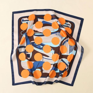 Detail of satin scarf featuring orange polka dots and nautical geometric patterns