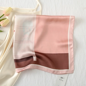 Detail of silk-satin square scarf with pink and mocha color blocking and delicate edges