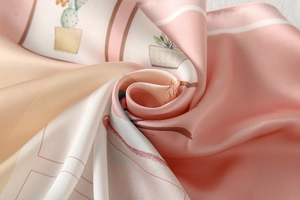 Close-up of pink satin silk scarf with elegant hand-drawn cactus illustration