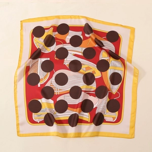 Macro shot of satin square scarf featuring geometric prints and elegant silk-like texture