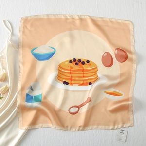 Detailed close-up of apricot silk scarf featuring hand-drawn breakfast pancake illustrations