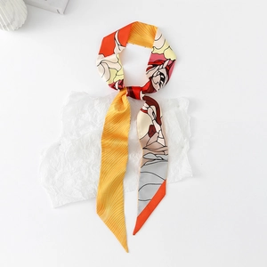 Close-up of vibrant floral and geometric twilly scarf with elegant silky texture
