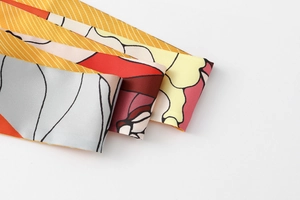 Close-up of elegant floral print silk scarves showing refined stitching and texture