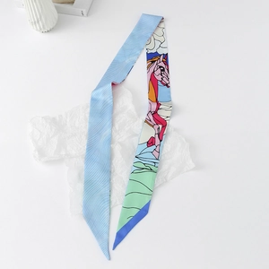 Detail of floral skinny silk scarf with colorful horse print on a white textured backdrop