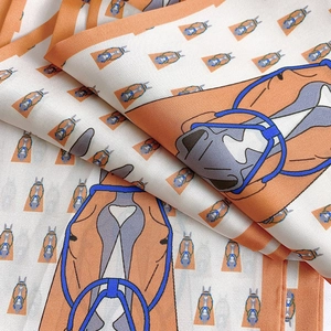 Detail of equestrian silk scarf with horse head print and fine rolled edges