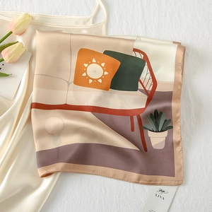 Detail shot of a satin silk square scarf with illustration, styled with tulips