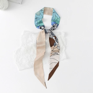 Detailed macro view of long silk-feel scarf with blue and brown wave patterns