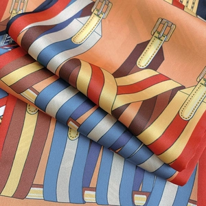 Detailed close-up of premium silk scarf with classic horse harness and buckle print pattern
