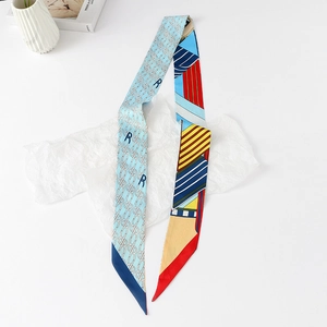 Macro view of floral skinny silk scarf with colorful geometric patterns and R-lettering