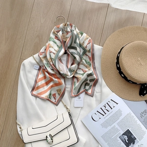 Detail of elegant silk scarf with geometric oil painting print over a white suit